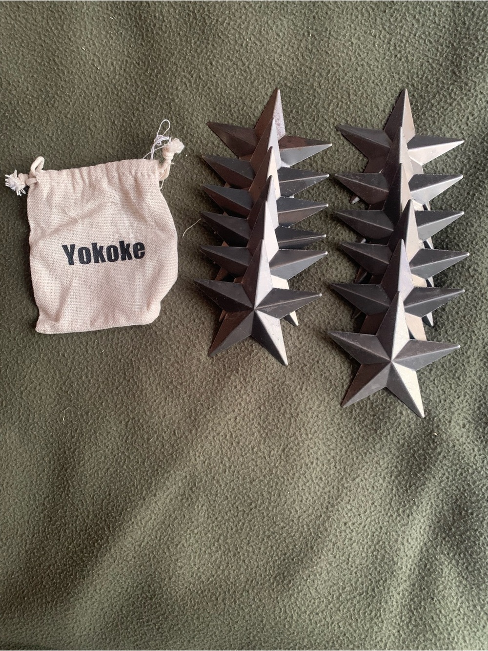 Yokoke rustic metal silver dimensional stars. 3.5”. Comes with bag.